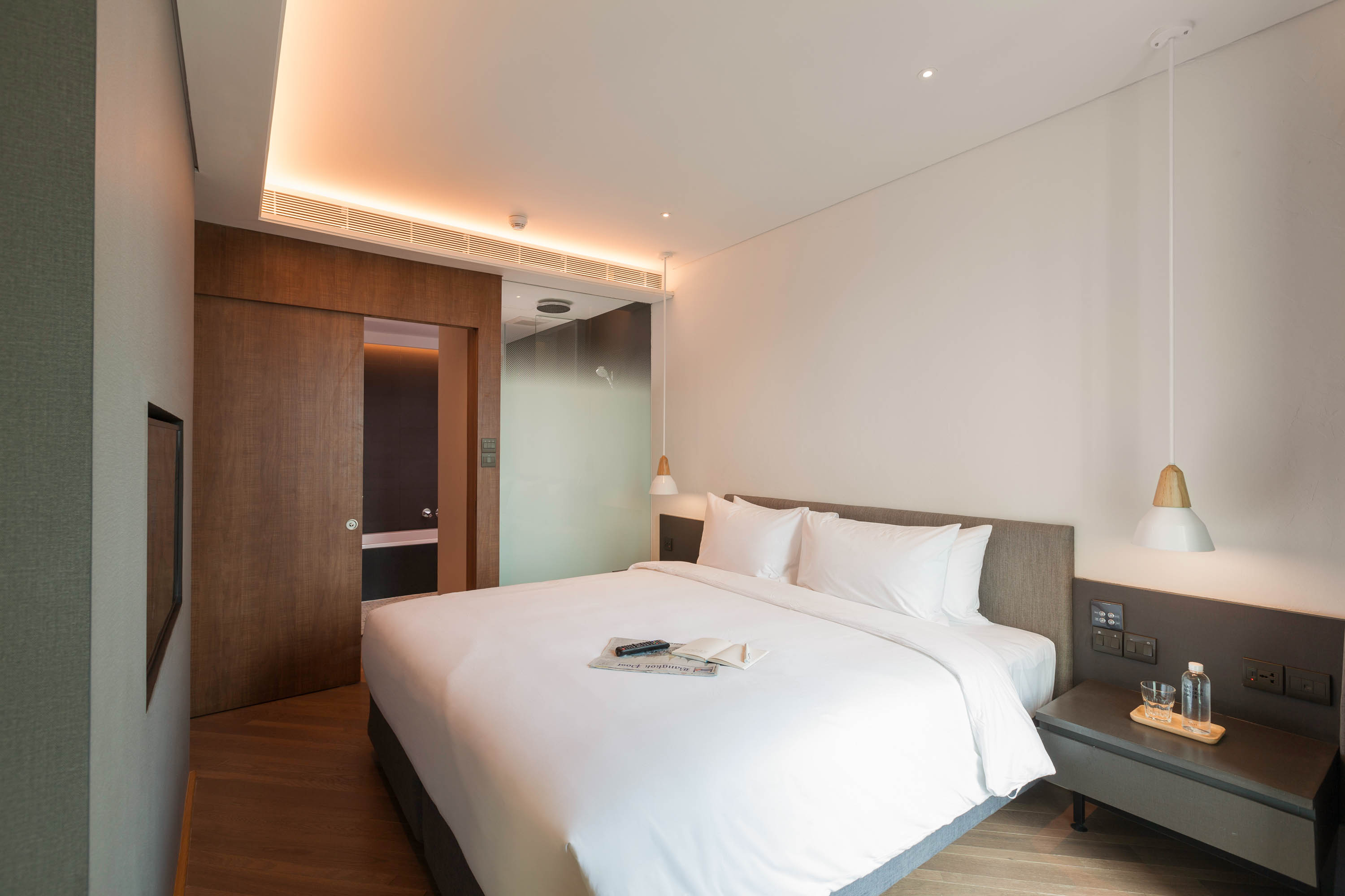 Master bedroom with a king bed in the Two Bedroom Suite at Volve Hotel Bangkok
